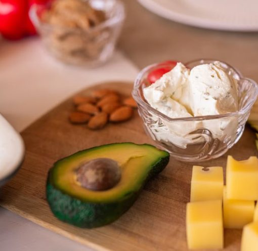 A vibrant platter of cheese, fruits, and vegetables on a wooden board, perfect for gatherings.